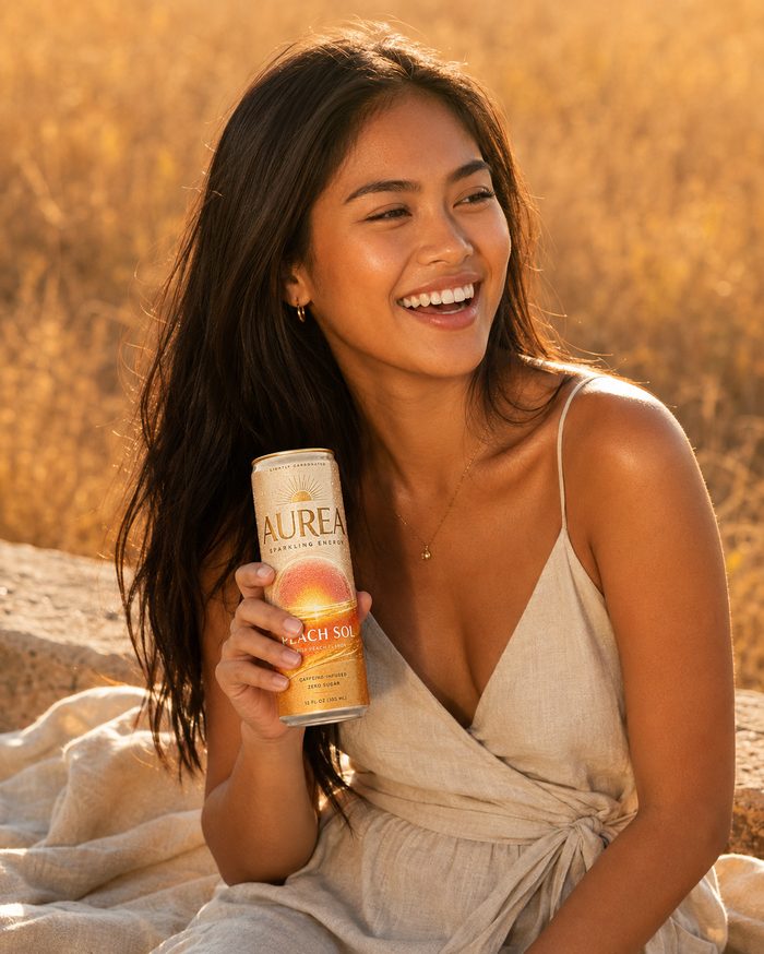 AUREA model holding Peach Sol, smiling