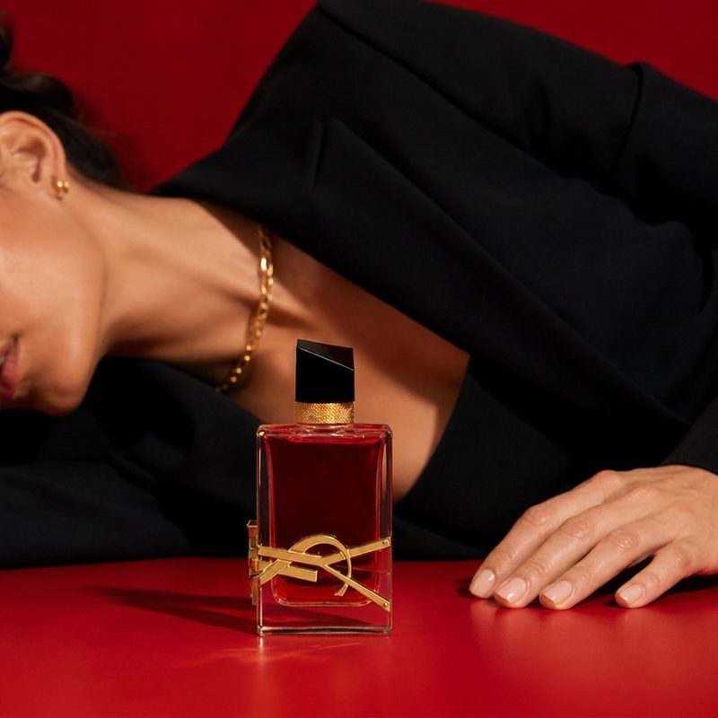 YSL Libre model lying on red table, editorial